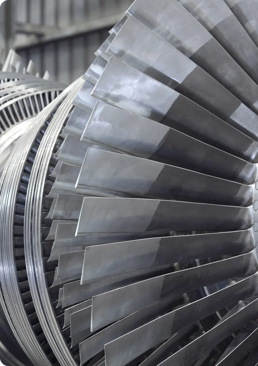 A close-up of a large turbine in a factory, showcasing its intricate design and industrial functionality.